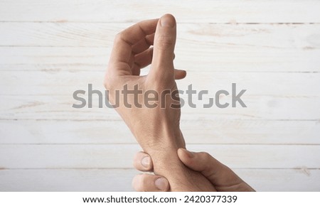 Extensor Tendon and Mallet Finger Injuries. part of left hand showing size, how big, long with index finger and thumb, index finger with a extensor tendon injury, mallet finger, tip bending downwards Royalty-Free Stock Photo #2420377339