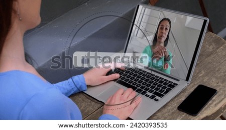 Image of speech bubble with thumbs up and numbers growing over woman using laptop on image call. Digital interface global social media and communication concept digitally generated image.