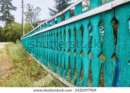 wooden picket fence with peeling paint Royalty-Free Stock Photo #2420397909