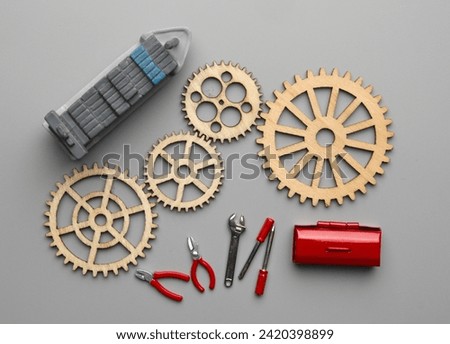 Flatlay picture of wooden gear with vessel, toolbox and tools. Technical and mechanical concept