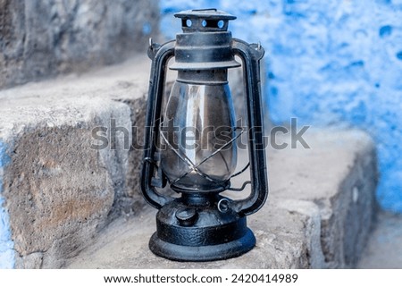 close up of an old blue vintage oil lamp with glass and metal in Cuzco Inca city in Peru