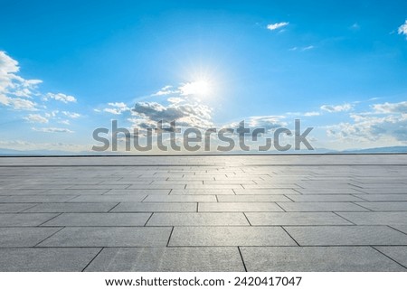 Empty square floor and sun with sky clouds background