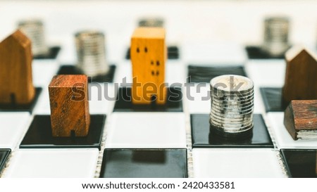 Stacks of coin money on chess broad with blur wood house model background, Real Estate market, Trading Estate, Mortgage Concepts