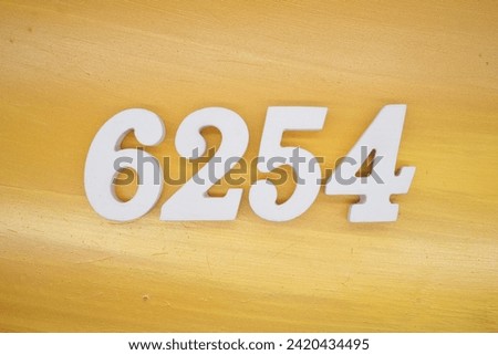 Gold background, numbers 6254 spray painted white.