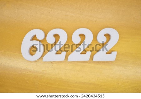 Gold background, numbers 6222 spray painted white.