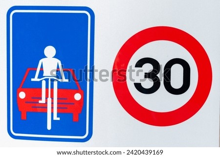 peed ​​limit sign up to 30 km and a sign informing about a bicycle path and a ban on overtaking cyclists. Information on the sign saying street for bicycles, ,road sign used in belgium 