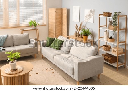 Interior of modern living room with sofas and plants Royalty-Free Stock Photo #2420444005