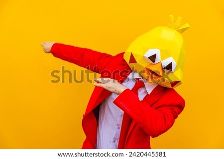 Cool man wearing 3d origami paper mask with stylish colorful clothing - Creative concept for advertising, animal head mask doing funny things on isolated colored background with copy-space