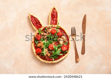 Tasty pizza on beige background. Easter celebration