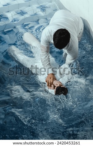 A Protestant pastor baptizes a man in water in the name of Jesus Christ Royalty-Free Stock Photo #2420453261