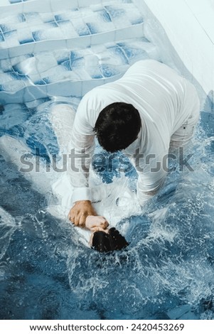 A Protestant pastor baptizes a man in water in the name of Jesus Christ Royalty-Free Stock Photo #2420453269