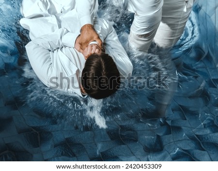 A Protestant pastor baptizes a man in water in the name of Jesus Christ Royalty-Free Stock Photo #2420453309