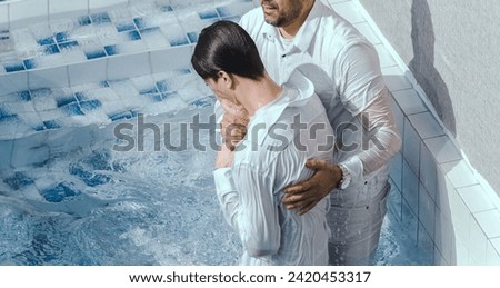 A Protestant pastor baptizes a man in water in the name of Jesus Christ Royalty-Free Stock Photo #2420453317