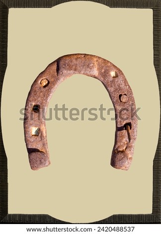 A framed horseshoe becomes a rustic art piece, emanating the strength and elegance of equestrian tradition. Wooden frames embrace the lucky symbol, offering an authentic and distinct appearance Royalty-Free Stock Photo #2420488537