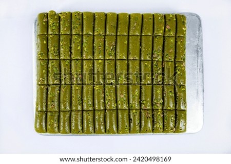 Top view of pistachio rolls on tray isolated on white background.