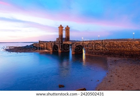 View of the historical bridge museum as the gate to San Gabriel Castle in Arrecife, Lanzarote Capital in Canary Islands, Spain Royalty-Free Stock Photo #2420502431