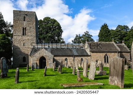 South elevation of St Andrew's Church in Bolam, Northumberland. Tower dates from the late Anglo-Saxon period Royalty-Free Stock Photo #2420505447