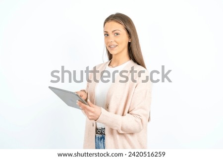 Photo of happy cheerful smart woman hold tablet browsing internet
