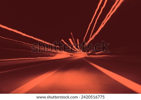 Mystical scene, night journey by car and lights, luminous flux, abstract background for text, red and orange photography