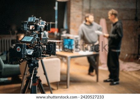 Professional cinema and video camera on the set. Shooting shift, lighting fixtures, shooting equipment and the team. Technique of modern filming and advertising.
