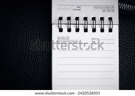 A notebook with springs on a black background. Empty notebook, stock photo