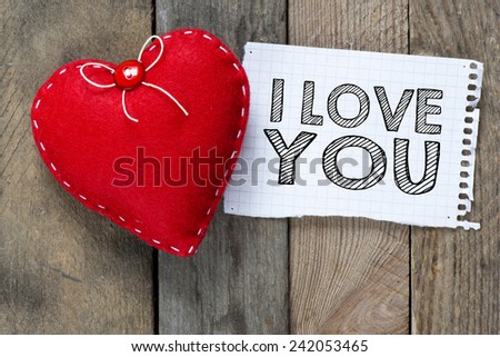 Card with with I love you. Card with I love you and heart on wooden background