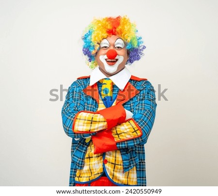 Mr Clown. Portrait of Funny comedian face Clown man in colorful uniform wearing wig standing arms crossed smiling to camera. Happy expression male bozo in various pose on isolated background.