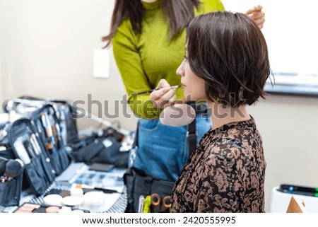 Japanese woman doing hair and makeup