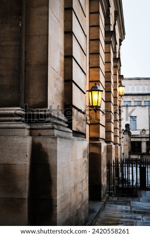 Glowing lamp on the side of old building 