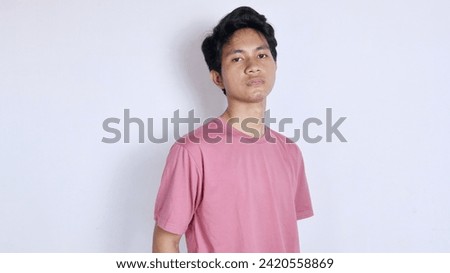 Handsome Asian man with a thin smile poses coolly on a white background Royalty-Free Stock Photo #2420558869