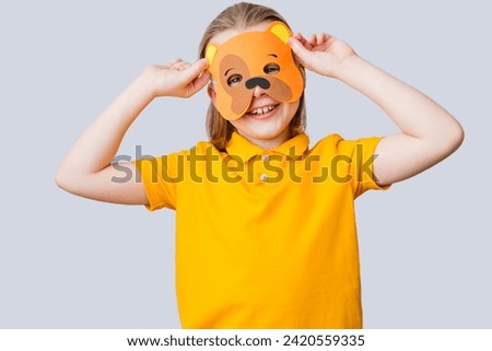 Cute bear on a gray background. A child in a handmade mask. Play accessories, photo booth props for kids. isolated