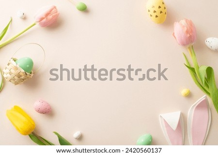 Springtime Joy Composition: Lively eggs, cute bunny ears, and tulips on a pastel beige background. Top view photo with an open frame ready for your text or promotional message