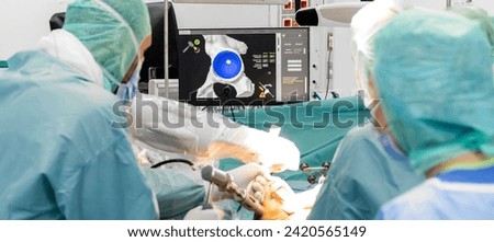 Team of doctor perform total hip arthroplasty replacement surgery in osteoarthritis patient inside the operating room. robot-assisted - robotic hip and knee replacement surgery	 Royalty-Free Stock Photo #2420565149