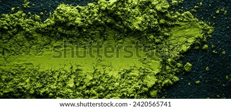high angle view of some colorful matcha powder tea on a dark textured stone surface, in a panoramic format to use as web banner or header Royalty-Free Stock Photo #2420565741