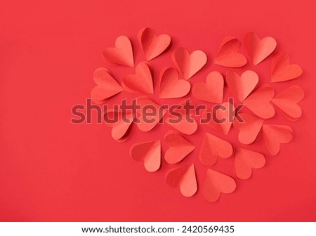 Valentine's Day background with red hearts on red background with copy space