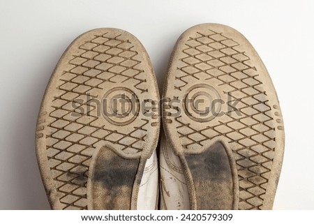 A Pair of Worn Sole White Sneakers Royalty-Free Stock Photo #2420579309