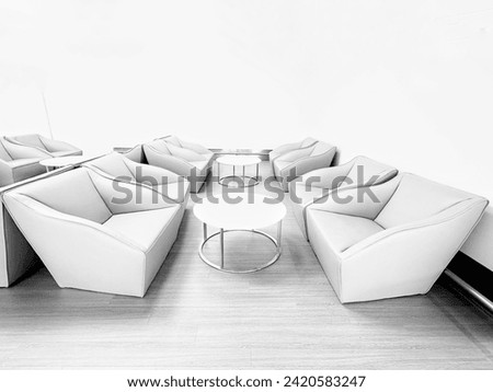 Blurred picture of Modern furniture that decorates the place beautifully, green and orange upholstered sofa chair placed in living room of house or in lobby of hotel to welcome guests and decorate.