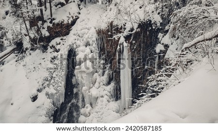 Huk waterfall, frozen waterfall at winter, Carpathian National Park. Ukraine. 