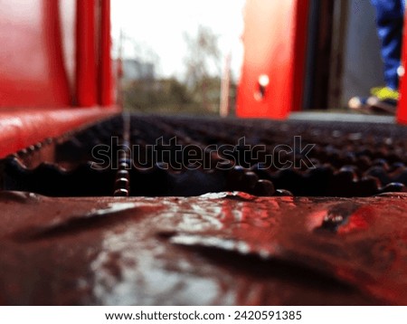 A low shot of the outer boarding platform of a red caboose. Royalty-Free Stock Photo #2420591385
