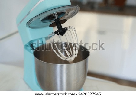 blue mixer with dough in the home kitchen. High quality photo Royalty-Free Stock Photo #2420597945