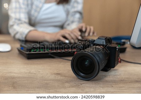 Freelance female photographer working happily from home Royalty-Free Stock Photo #2420598839
