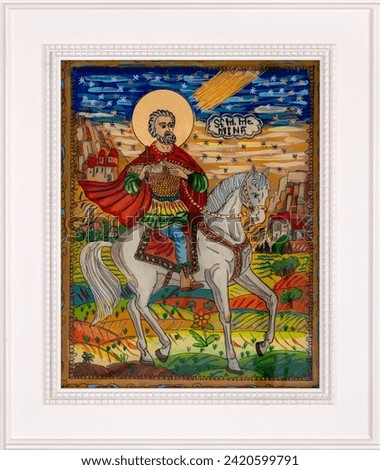 Icon painted on reverse glass in the naive orthodox style of Eastern Europe depicting Saint Mina of Egypt. Framed icon. Royalty-Free Stock Photo #2420599791