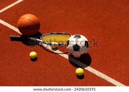 A group of sports equipment on black background including tennis, basketball, and soccer and boxing equipment on a background with copy space Royalty-Free Stock Photo #2420610191