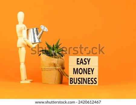 Easy money business symbol. Concept words Easy money business on beautiful wooden blocks. Beautiful orange table orange background. Businessman icon. Easy money business concept. Copy space.