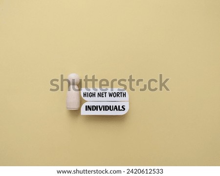 Wooden figure with the words High Net Worth Individuals. Concept of property value