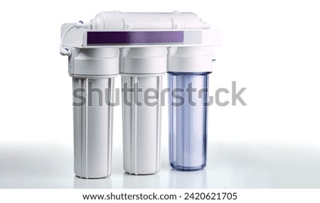 Three stage home water filtration system isolated on a white background. Royalty-Free Stock Photo #2420621705
