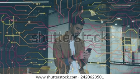 Image of data processing over biracial businessman using smartphone. Global online security, digital interface, computing and data processing concept digitally generated image.