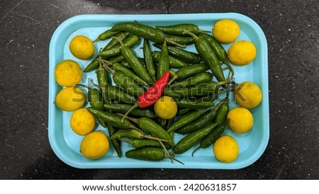 Vegetables.
lemons and green chilies'.
Veg Picture.
Plate full of chilies and lemons.
