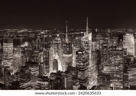 New York City midtown skyline with skyscrapers and urban cityscape at night.