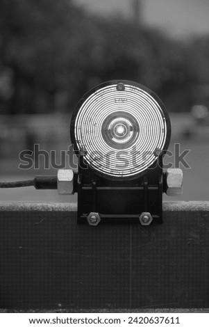 A Black And White photograph of a Railway traffic control light. It was created near the Kissimmee Train Station Depot.